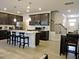 Spacious open-concept kitchen with dark wood cabinets, granite countertops, and stainless steel appliances at 519 Flat Ford Rd, Hillsborough, NC 27278