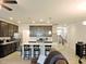 Open kitchen features dark cabinetry, stainless steel appliances, and a large island with bar seating at 519 Flat Ford Rd, Hillsborough, NC 27278