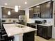 Kitchen featuring dark cabinets, white backsplash, granite countertops, and stainless steel appliances at 519 Flat Ford Rd, Hillsborough, NC 27278