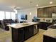 Open concept kitchen with a large island, granite counters, dark cabinets, and stainless steel appliances at 519 Flat Ford Rd, Hillsborough, NC 27278