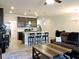 Open living space boasts a kitchen island with barstool seating and a comfortable brown sofa set at 519 Flat Ford Rd, Hillsborough, NC 27278