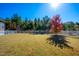 Spacious backyard with mature trees, a white fence and manicured lawn at 52 N Rosebank Dr, Chapel Hill, NC 27516