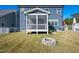 Exterior shot showcasing the backyard, screen porch, and fire pit for outdoor enjoyment at 52 N Rosebank Dr, Chapel Hill, NC 27516