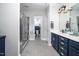 This primary bathroom features a tiled shower and double sink vanity with gold hardware at 52 N Rosebank Dr, Chapel Hill, NC 27516