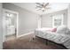 This bedroom has neutral paint, a ceiling fan and a connected bath at 52 N Rosebank Dr, Chapel Hill, NC 27516
