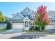 Charming two-story home with a well-manicured lawn, two-car garage, and mature tree at 52 N Rosebank Dr, Chapel Hill, NC 27516