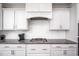 This kitchen features white cabinets, granite countertops, stainless steel appliances, and a stylish tile backsplash at 52 N Rosebank Dr, Chapel Hill, NC 27516