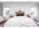The main bedroom features wood paneling, two windows, and pendant lighting at 52 N Rosebank Dr, Chapel Hill, NC 27516