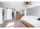 The primary bedroom showcases a ceiling fan, closet, and barn door to the bathroom at 52 N Rosebank Dr, Chapel Hill, NC 27516