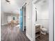 Stylish powder room with a barn door, sleek vanity, and modern fixtures at 52 N Rosebank Dr, Chapel Hill, NC 27516