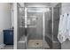 A tiled shower with dual shower heads, pebble floor, and glass door at 52 N Rosebank Dr, Chapel Hill, NC 27516