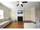 Spacious living room with a fireplace, hardwood floors, and comfortable seating at 5204 Sapphire Springs Dr, Knightdale, NC 27545