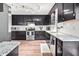 Spacious kitchen featuring dark cabinets, stainless steel appliances, and granite countertops at 5216 Passenger Pl, Raleigh, NC 27603