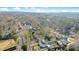 Wide aerial shot displays a peaceful neighborhood with houses surrounded by abundant trees and serene streets at 527 N Main St, Wake Forest, NC 27587