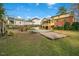Wide backyard showcasing a lush lawn, mature trees, and outdoor amenities for leisure and recreation at 527 N Main St, Wake Forest, NC 27587