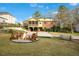 Backyard with a fire pit and seating, complemented by lush greenery and a glimpse of the house at 527 N Main St, Wake Forest, NC 27587