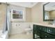 Well-lit bathroom with modern fixtures, a vanity, and a shower, providing a comfortable space at 527 N Main St, Wake Forest, NC 27587