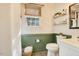Well-lit bathroom featuring a window, toilet, and white textured wallpaper for a cozy and bright aesthetic at 527 N Main St, Wake Forest, NC 27587
