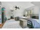 Well-lit bedroom featuring two beds, ceiling fan, and windows overlooking the outdoors at 527 N Main St, Wake Forest, NC 27587