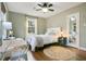 Relaxing bedroom with a white bed, a wooden desk, and natural light at 527 N Main St, Wake Forest, NC 27587