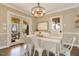 Elegant dining room featuring a chandelier, a well-dressed table and natural light at 527 N Main St, Wake Forest, NC 27587