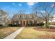 Charming brick home featuring dormer windows and a well-manicured front yard at 527 N Main St, Wake Forest, NC 27587