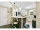 Open kitchen design with breakfast bar, stainless steel appliances, and stylish pendant lighting at 527 N Main St, Wake Forest, NC 27587