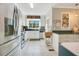 Bright kitchen featuring stainless steel appliances, white cabinetry, and tile flooring at 527 N Main St, Wake Forest, NC 27587