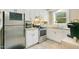 Bright kitchen features stainless steel appliances, white cabinetry, and a window offering natural light at 527 N Main St, Wake Forest, NC 27587