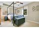 Inviting bedroom with a four-poster bed, side table, and window, creating a peaceful retreat at 527 N Main St, Wake Forest, NC 27587