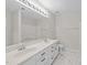 Ensuite bathroom with double sink vanity and large wall mirror with custom vanity lights at 5421 Vista View Ct, Raleigh, NC 27612