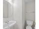 This powder room features a pedestal sink, rounded mirror, and a convenient toilet at 5421 Vista View Ct, Raleigh, NC 27612