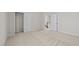 Carpeted bedroom showing closet, stairway, and entry to another room with neutral colors at 5421 Vista View Ct, Raleigh, NC 27612