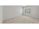 Bedroom featuring neutral paint and carpet and a large window overlooking a natural area at 5421 Vista View Ct, Raleigh, NC 27612