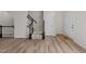 Bright foyer with beautiful wood flooring and staircase with black and white banister at 5421 Vista View Ct, Raleigh, NC 27612