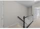 Hallway with stairway features neutral carpet and paint, and white risers on the stairs at 5421 Vista View Ct, Raleigh, NC 27612