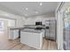 Stylish kitchen with white cabinets, stainless steel appliances, an island and a view to an outdoor deck at 5421 Vista View Ct, Raleigh, NC 27612