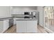 Modern kitchen featuring white cabinets, stainless steel appliances, gray countertops and a kitchen island at 5421 Vista View Ct, Raleigh, NC 27612