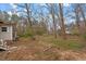 Large backyard featuring a partial patio, mature trees, and room for outdoor activities at 5505 Farrington Rd, Chapel Hill, NC 27517