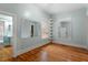 A bedroom featuring hardwood floors, built-in shelving and mirrors at 5505 Farrington Rd, Chapel Hill, NC 27517