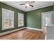 Cozy bedroom featuring hardwood floors, and bright double windows at 5505 Farrington Rd, Chapel Hill, NC 27517
