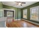 Green-walled bedroom showcasing hardwood floors, bright windows, and generous trim at 5505 Farrington Rd, Chapel Hill, NC 27517