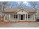 Charming single-story home featuring a cozy front porch and a well-maintained yard at 5505 Farrington Rd, Chapel Hill, NC 27517