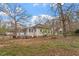 Quaint single-Gathering home featuring a brick chimney and inviting front porch with a chair at 5505 Farrington Rd, Chapel Hill, NC 27517