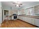Well-lit kitchen featuring wood floors, light blue walls, and vintage shelving at 5505 Farrington Rd, Chapel Hill, NC 27517