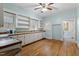 Bright kitchen with light-blue walls, wood floors, shelving, and appliances at 5505 Farrington Rd, Chapel Hill, NC 27517
