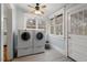 Laundry room with washer and dryer, two windows, and white trim at 5505 Farrington Rd, Chapel Hill, NC 27517