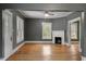 Inviting living room with hardwood floors, a fireplace, and a ceiling fan at 5505 Farrington Rd, Chapel Hill, NC 27517