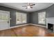 Spacious living room with hardwood floors, a ceiling fan, and a fireplace at 5505 Farrington Rd, Chapel Hill, NC 27517