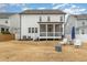 Backyard with a screened-in porch, furniture and well-maintained lawn at 562 Boulder Point Dr, Chapel Hill, NC 27516